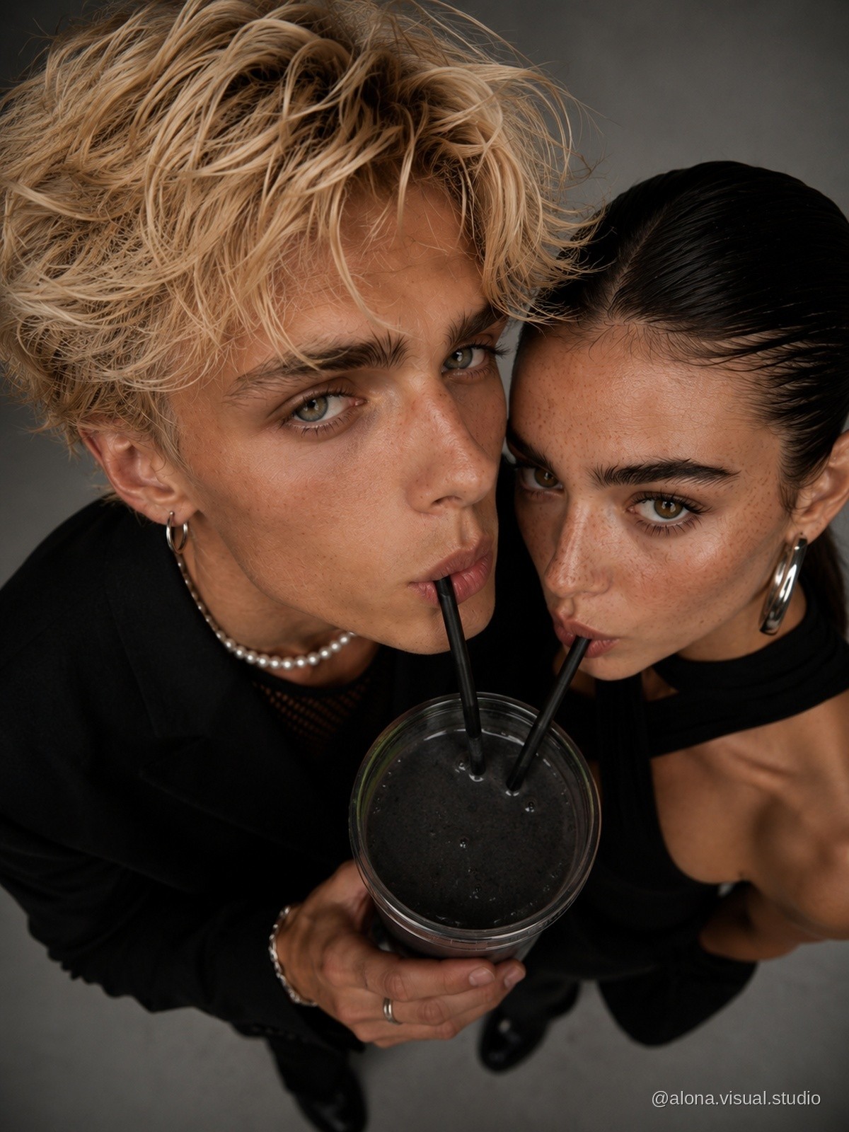 Playful fashion portrait with a shared drink